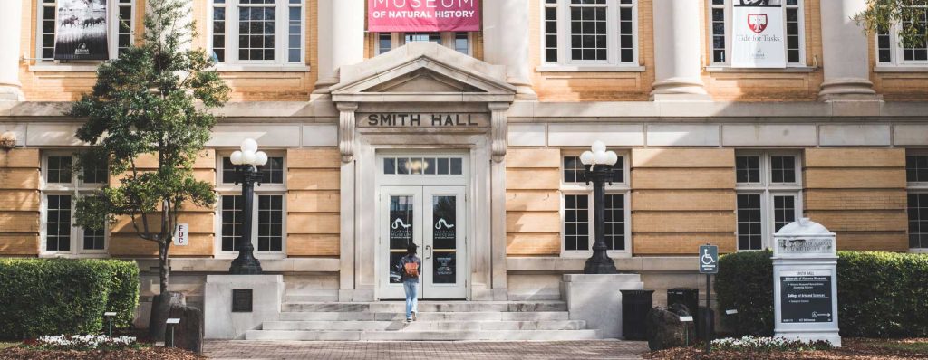 Smith Hall, a yellow brick building that is home to the Alabama Museum of Natural History